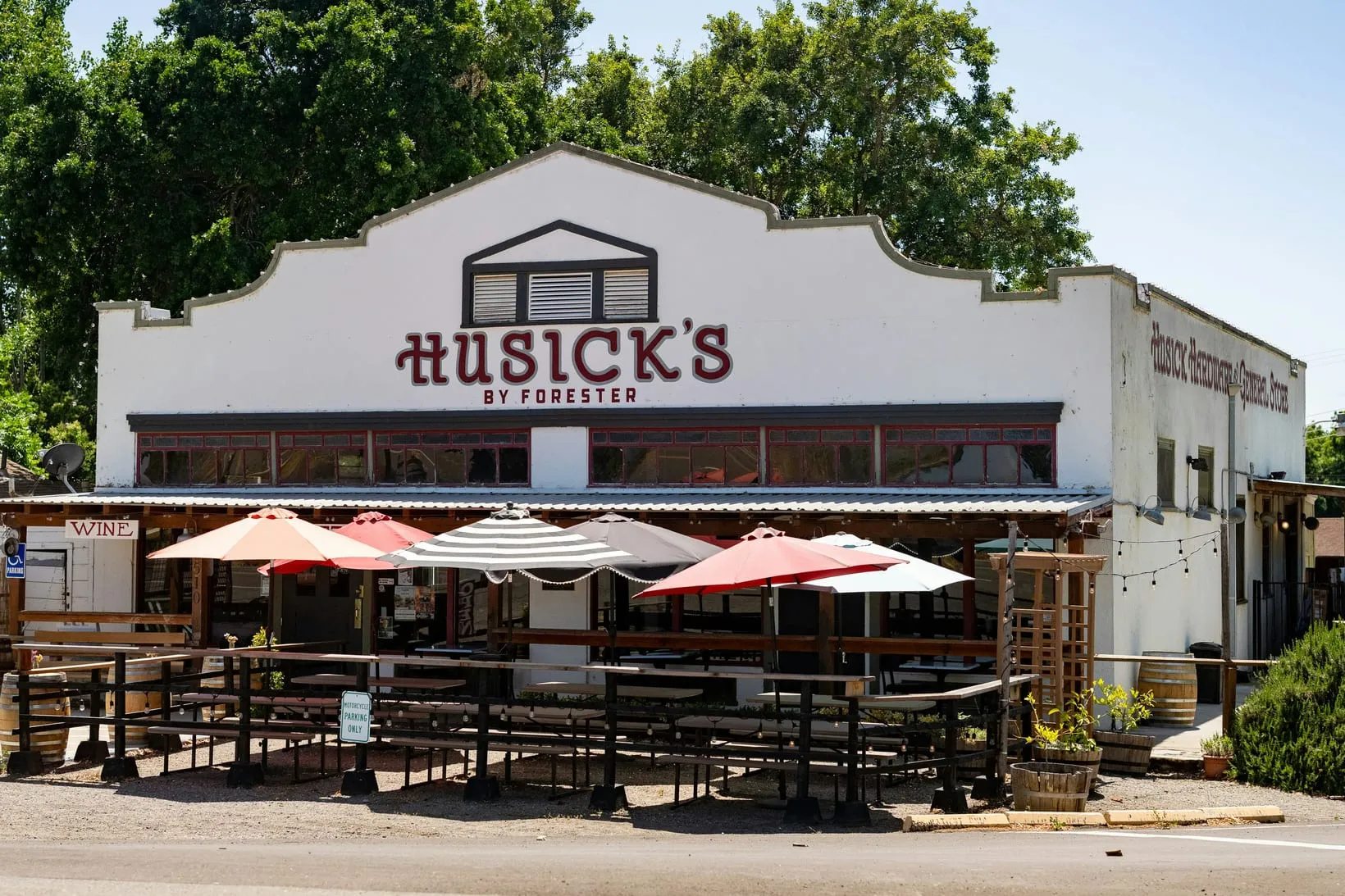 Restaurant building with an outdoor patio and red umbrellas