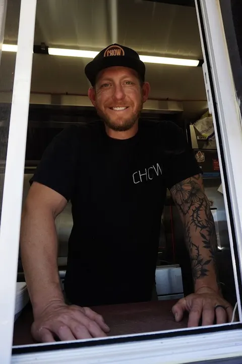 Chris Kindred in the window of the CHOW food truck